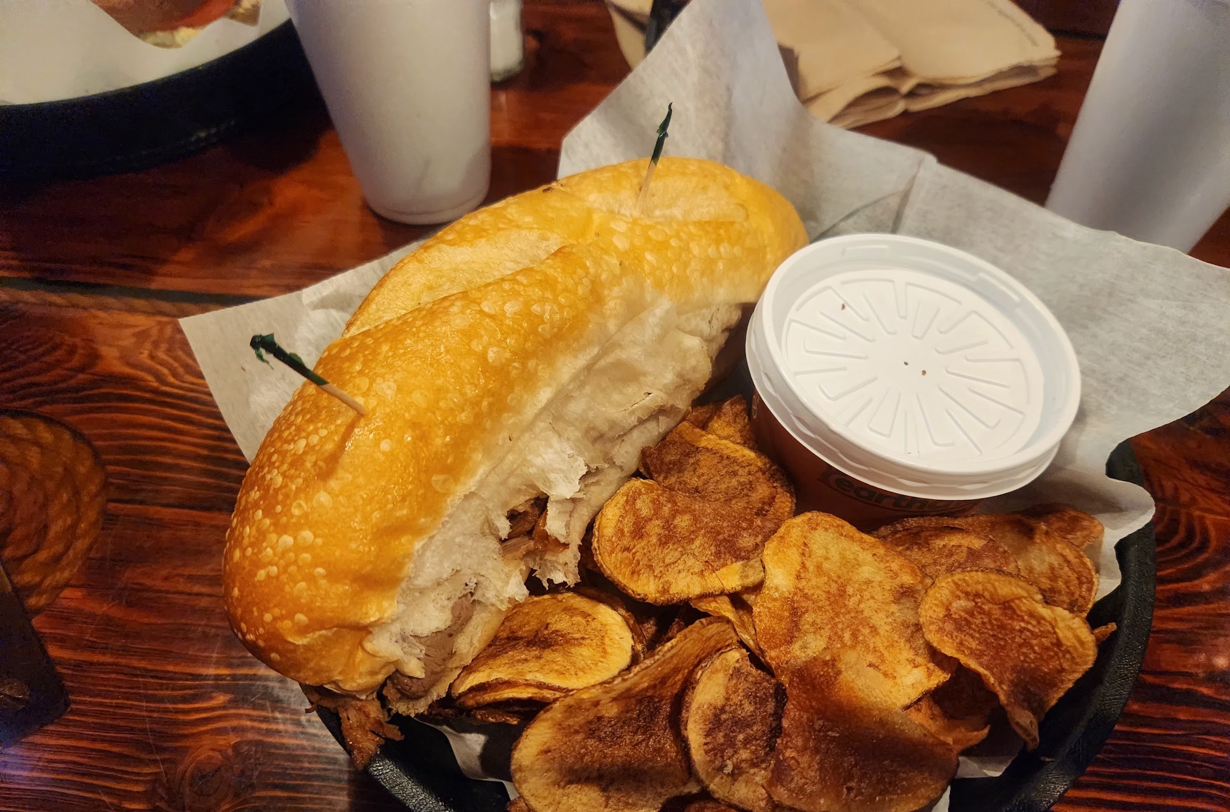 French dip with house chips in a cast-iron skillet