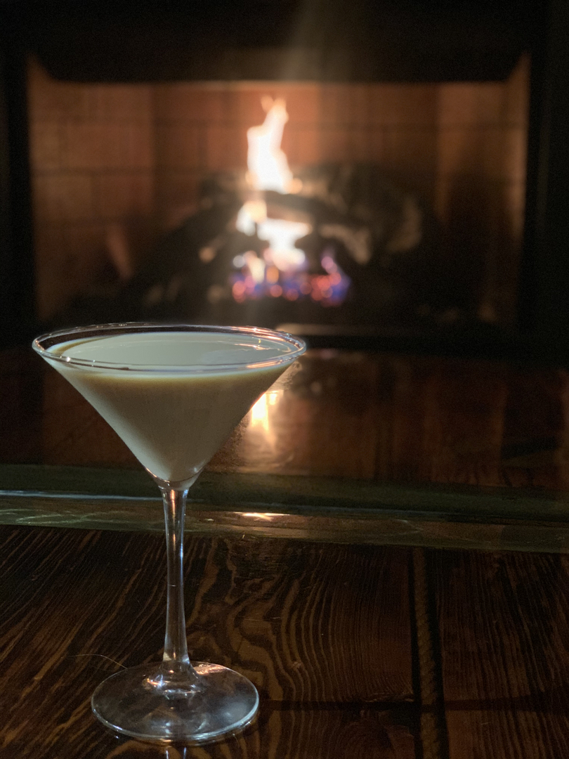 An evening cocktail by the fireplace
