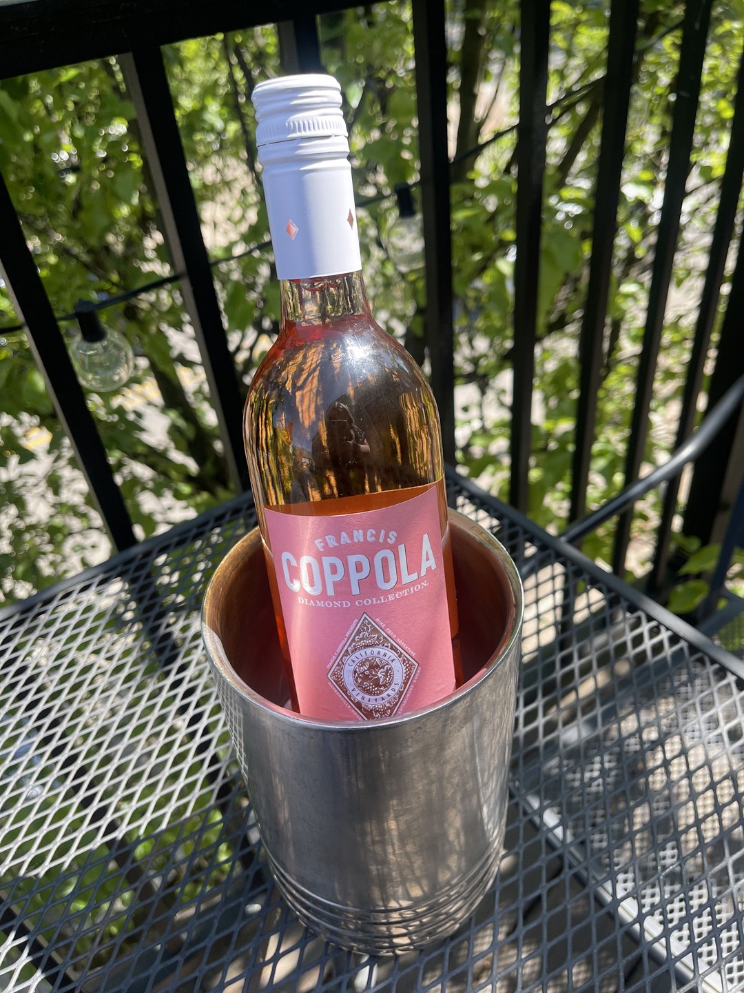 A bottle of rosé chilling on the rooftop patio table
